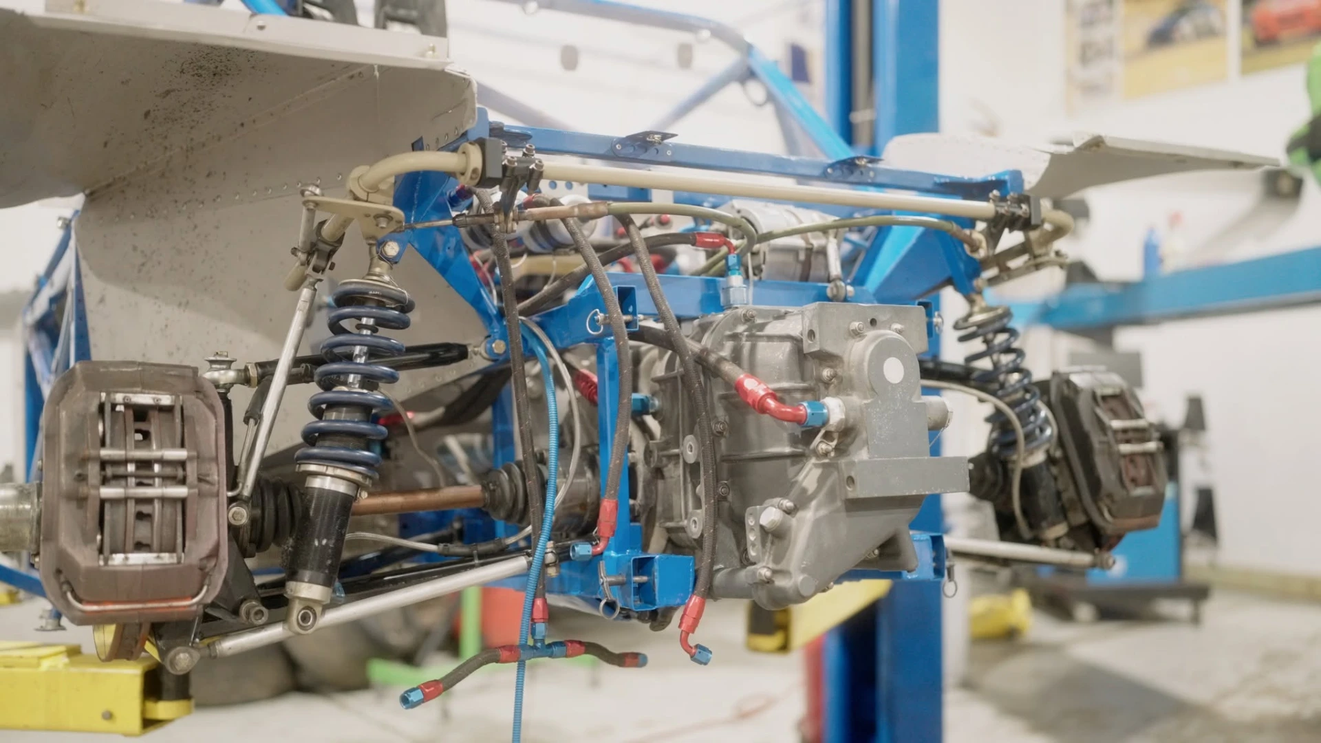 Rear suspension, transaxle and brake assembly of a race car on the lift