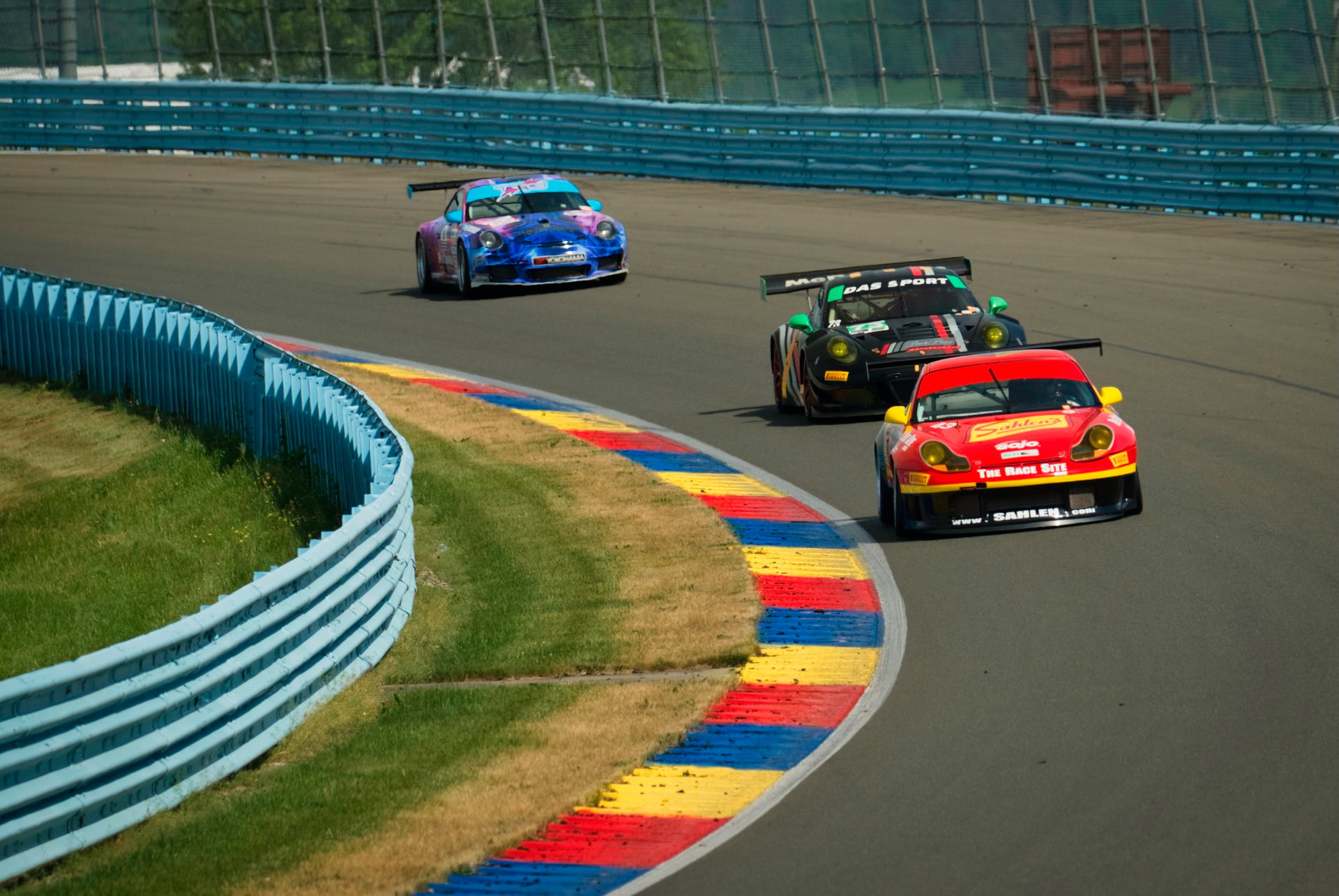 Porsche race cars nose-to-tail at Watkins Glen